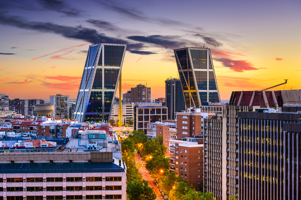 Madrid, Spain financial district skyline at twilight viewed towards the Gates of Europe.